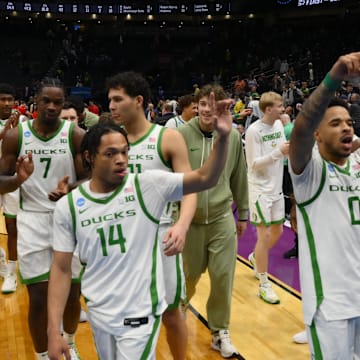 Mar 21, 2025; Seattle, WA, USA; Oregon Ducks guard Jayson Williams-Johnson (14) and guard Ra'Heim Moss (0) react after the game against the Liberty Flames in the first round of the NCAA Tournament at Climate Pledge Arena. Mandatory Credit: Steven Bisig-Imagn Images