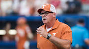 Jun 5, 2025; Oklahoma City, OK, USA;  
Texas Longhorns head coach Mike White heads to the third base coaches box in the second inning against the Texas Tech Red Raiders during game two of the NCAA Softball Women's College World Series finals at Devon Park. Mandatory Credit: Brett Rojo-Imagn Images