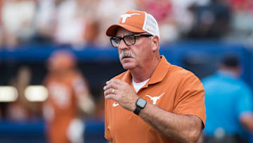 Jun 5, 2025; Oklahoma City, OK, USA;  
Texas Longhorns head coach Mike White heads to the third base coaches box in the second inning against the Texas Tech Red Raiders during game two of the NCAA Softball Women's College World Series finals at Devon Park. Mandatory Credit: Brett Rojo-Imagn Images