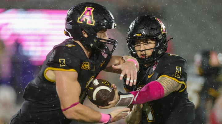 Dec 16, 2023; Orlando, FL, USA;  Appalachian State Mountaineers quarterback Joey Aguilar (4) hands off to Appalachian State Mountaineers running back Anderson Castle (1) against the Miami (OH) Redhawks in the third quarter in the third quarter during the Avocados from Mexico Cure Bowl at FBC Mortgage Stadium. Mandatory Credit: Nathan Ray Seebeck-USA TODAY Sports