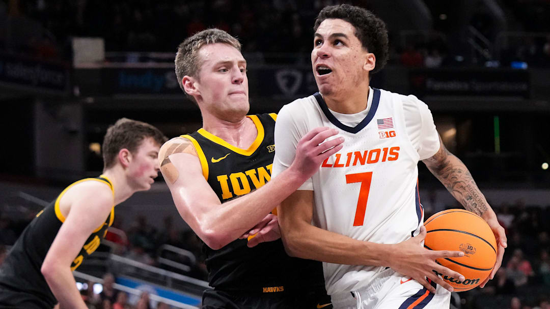 Illinois Fighting Illini forward Will Riley (7) rushes past Iowa Hawkeyes forward Payton Sandfort (20) on Thursday, March 13, 2025, during the second round of the men's Big Ten tournament at Gainbridge Fieldhouse in Indianapolis. The Illinois Fighting Illini defeated the Iowa Hawkeyes, 106-94.