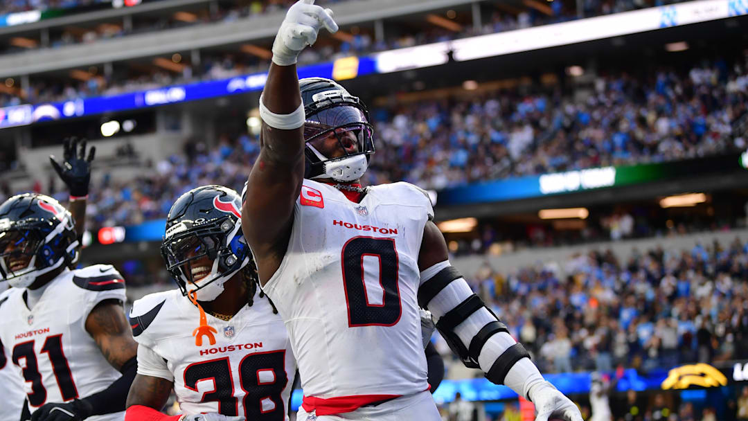 Dec 27, 2025; Inglewood, California, USA;  Houston Texans linebacker Azeez al-Shaair (0) reacts with safety K'Von Wallace (38) after making an interception against the Los Angeles Chargers during the first half at SoFi Stadium. Mandatory Credit: Gary A. Vasquez-Imagn Images