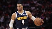 Apr 13, 2025; Houston, Texas, USA;  Denver Nuggets guard Russell Westbrook (4) dribbles against the Houston Rockets in the second half at Toyota Center. Mandatory Credit: Thomas Shea-Imagn Images