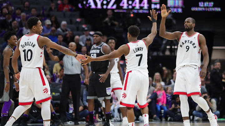 Dec 10, 2017; Sacramento, CA, USA; Toronto Raptors guard Kyle Lowry (7) celebrates with guard DeMar DeRozan (10) and forward Serge Ibaka (9) during the third quarter against the Sacramento Kings at Golden 1 Center. Mandatory Credit: Sergio Estrada-Imagn Images