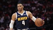 Apr 13, 2025; Houston, Texas, USA;  Denver Nuggets guard Russell Westbrook (4) dribbles against the Houston Rockets in the second half at Toyota Center. Mandatory Credit: Thomas Shea-Imagn Images