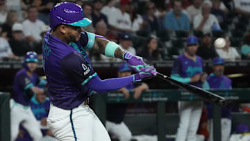 Sep 5, 2025; Phoenix, Arizona, USA; Arizona Diamondbacks second base Ketel Marte (4) hits against the Boston Red Sox in the first inning at Chase Field.