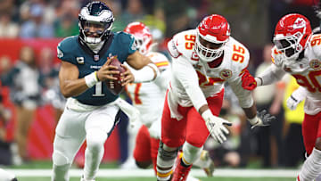 Feb 9, 2025; New Orleans, LA, USA; Philadelphia Eagles quarterback Jalen Hurts (1) runs past Kansas City Chiefs defensive tackle Chris Jones (95) in the second half in Super Bowl LIX at Ceasars Superdome. Mandatory Credit: Mark J. Rebilas-Imagn Images