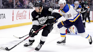 Mar 8, 2025; Los Angeles, California, USA; Los Angeles Kings left wing Andrei Kuzmenko (96) moves the puck ahead of St. Louis Blues defenseman Ryan Suter (22) during the second period at Crypto.com Arena. Mandatory Credit: Ryan Sun-Imagn Images