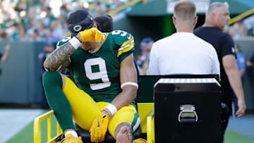 Green Bay Packers wide receiver Christian Watson (9) is carted off the field after getting injured during their football game against the Minnesota Vikings.