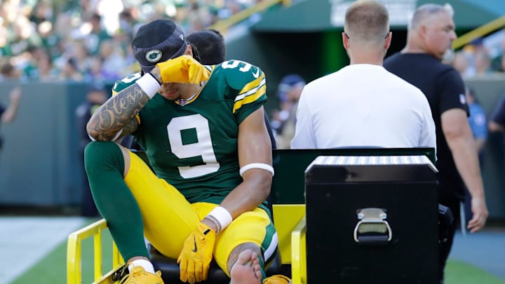 Green Bay Packers wide receiver Christian Watson (9) is carted off the field after getting injured during their football game against the Minnesota Vikings.
