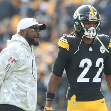 Nov 17, 2024; Pittsburgh, Pennsylvania, USA;  Pittsburgh Steelers head coach Mike Tomlin (left) and running back Najee Harris (22) talk during warm ups before the game against the Baltimore Ravens at Acrisure Stadium. Mandatory Credit: Charles LeClaire-Imagn Images