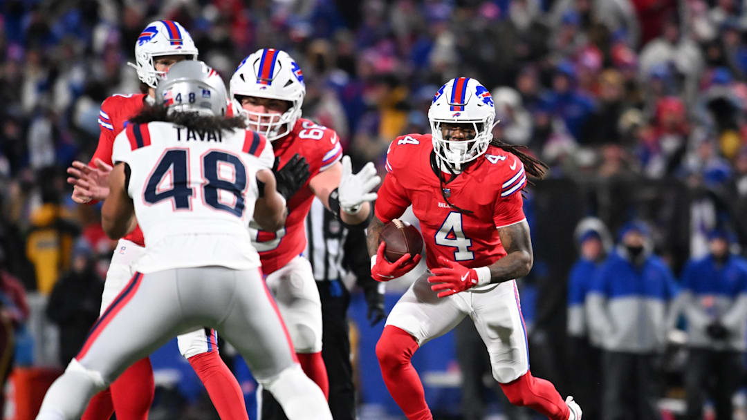 Dec 22, 2024; Orchard Park, New York, USA; Buffalo Bills running back James Cook (4) uses blockers to gain yards against the New England Patriots in the third quarter at Highmark Stadium. Mandatory Credit: Mark Konezny-Imagn Images