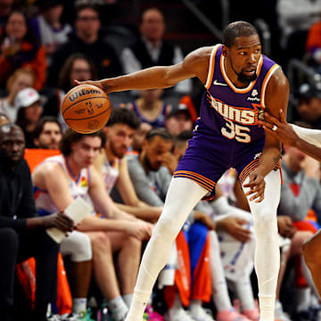 Mar 3, 2024; Phoenix, Arizona, USA; Phoenix Suns forward Kevin Durant (35) handles the ball against Oklahoma City Thunder guard Shai Gilgeous-Alexander (2) during the second quarter at Footprint Center. Mandatory Credit: Mark J. Rebilas-Imagn Images
