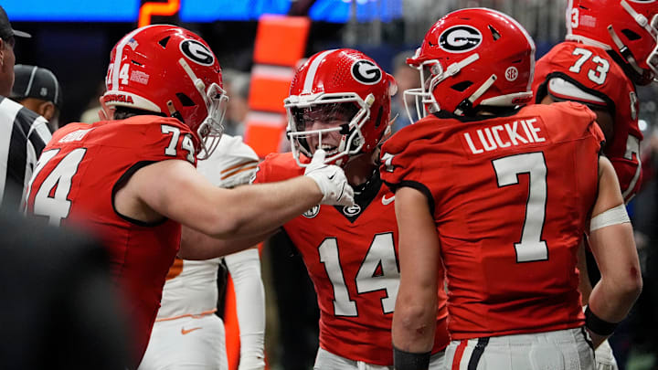 Georgia quarterback Gunner Stockton (14) celebrates with his teammates after leading the offense to a touchdown score after Georgia quarterback Carson Beck (15) had to leave the game during the second half of the SEC championship game against Texas in Atlanta, on Saturday, Dec. 7, 2024.