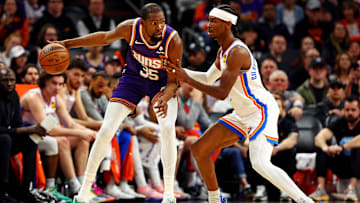 Mar 3, 2024; Phoenix, Arizona, USA; Phoenix Suns forward Kevin Durant (35) handles the ball against Oklahoma City Thunder guard Shai Gilgeous-Alexander (2) during the second quarter at Footprint Center. Mandatory Credit: Mark J. Rebilas-Imagn Images