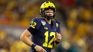 Cade McNamara #12 of the Michigan Wolverines reacts during the second quarter of the game against the Georgia Bulldogs in the Capital One Orange Bowl for the College Football Playoff semifinal game at Hard Rock Stadium on December 31, 2021 in Miami Gardens, Florida.