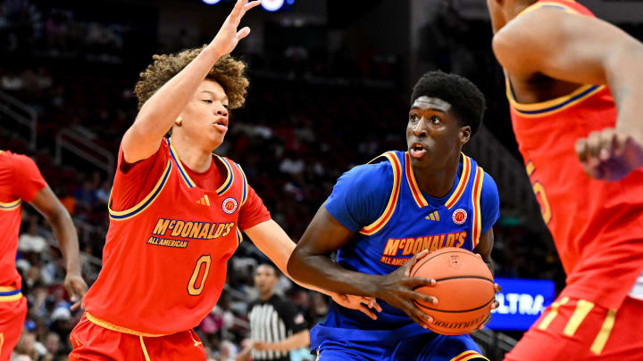 Apr 2, 2024; Houston, TX, USA; McDonald's All American East guard Drake Powell (9) drives to the basket around McDonald's All American West guard Trent Perry (0) during the first half at Toyota Center. Mandatory Credit: Maria Lysaker-USA TODAY Sports