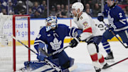 Toronto Maple Leafs goaltender Anthony Stolarz and Florida Panthers forward Sam Bennett battle for position in front of the goal.