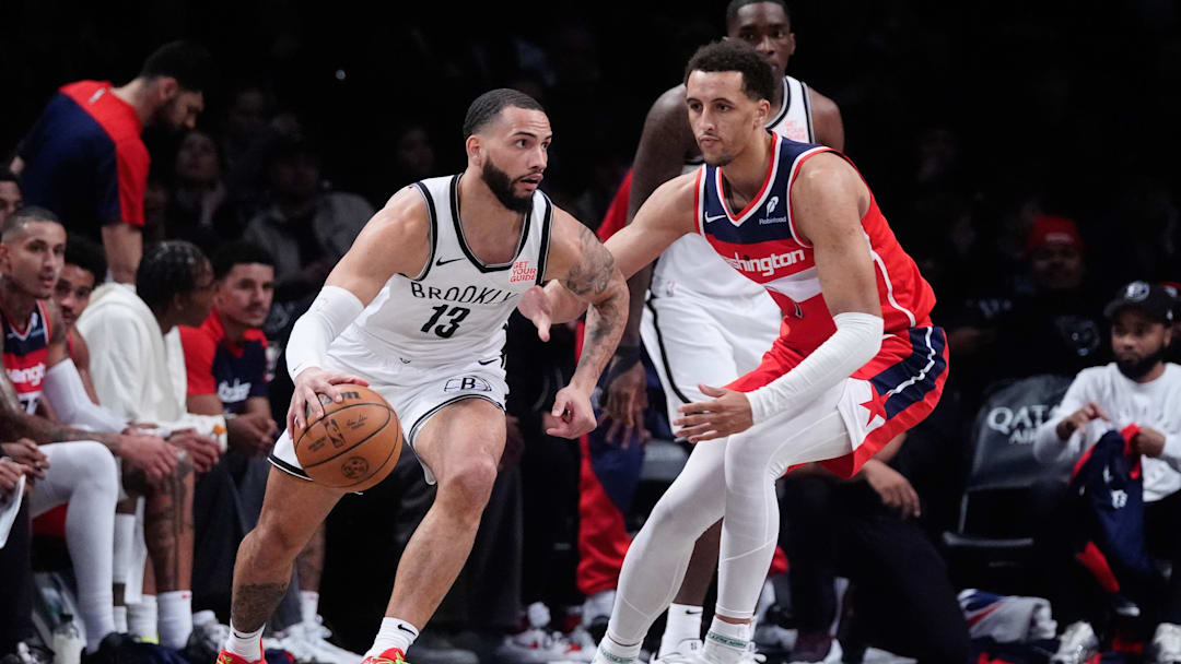 Oct 14, 2024; Brooklyn, New York, USA; Brooklyn Nets small guard Shake Milton (13) dribbles the ball against Washington Wizards forward Patrick Baldwin Jr. (7) during the second half at Barclays Center. Mandatory Credit: Gregory Fisher-Imagn Images