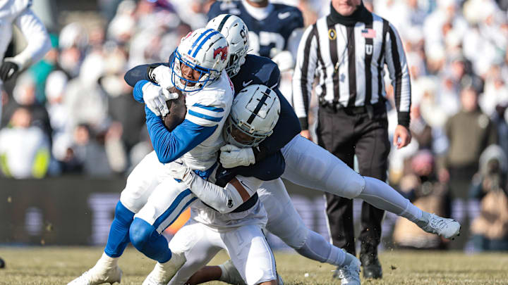 Southern Methodist Mustangs running back Brashard Smith (1) carries the ball during the first half as Penn State Nittany Lions defensive end Smith Vilbert (92) and safety Jaylen Reed (1) tackles at Beaver Stadium. Southern Methodist Mustangs running back Brashard Smith (1) carries the ball during the first half as Penn State Nittany Lions defensive end Smith Vilbert (92) and safety Jaylen Reed (1) tackles at Beaver Stadium.