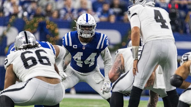 Colts linebacker Zaire Franklin (blue jersey; white helmet) gets ready to play defense before the ball is snapped. 