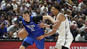 Jul 12, 2025; Las Vegas, NV, USA; Dallas Mavericks forward Cooper Flagg (32) drives past San Antonio Spurs forward Carter Bryant (11) in the fourth quarter of their game at Thomas & Mack Center. Mandatory Credit: Candice Ward-Imagn Images