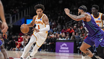Nov 23, 2025; Atlanta, Georgia, USA; Atlanta Hawks forward Jalen Johnson (1) drives with the ball against Charlotte Hornets forward Miles Bridges (0) during the first half at State Farm Arena. Mandatory Credit: Dale Zanine-Imagn Images