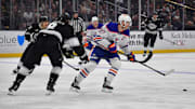 Apr 29, 2025; Los Angeles, California, USA; Edmonton Oilers center Connor McDavid (97) moves the puck against Los Angeles Kings defenseman Drew Doughty (8) during the third period in game five of the first round of the 2025 Stanley Cup Playoffs at Crypto.com Arena. Mandatory Credit: Gary A. Vasquez-Imagn Images