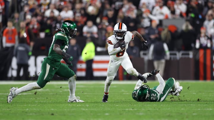 Dec 28, 2023; Cleveland, Ohio, USA; Cleveland Browns wide receiver Elijah Moore (8) runs with the ball past New York Jets safety Tony Adams (22) during the first half at Cleveland Browns Stadium. Mandatory Credit: Scott Galvin-USA TODAY Sports