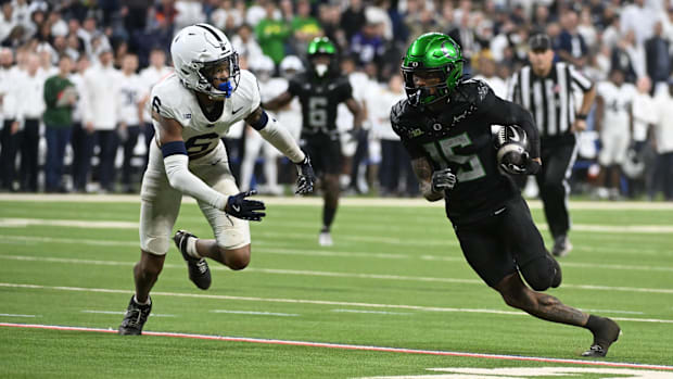 Oregon Ducks wide receiver Tez Johnson (15) runs for a gain past coverage from Penn State Nittany Lions safety Zakee Wheatley