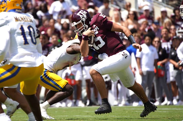 Texas A&M Aggies quarterback Conner Weigman (15) runs the ball during the second quarter against the McNeese State Cowboys.