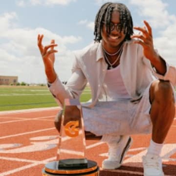 Tate Taylor poses with the 2025 Gatorade National Track and Field Player of the Year Award during a photoshoot after the surprise announcement on Thursday, July 26, 2025 at San Antonio's John M. Harlan High School.