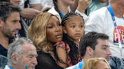 Serena Williams holds daughter Olympia while watching the women's gymnastics team final at the 2024 Paris Olympics.