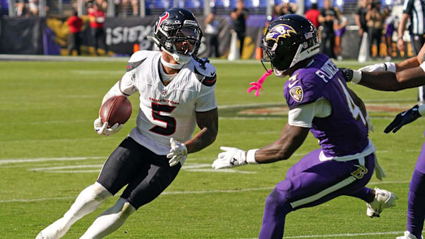 Oct 5, 2025; Baltimore, Maryland, USA; Houston Texans safety Jalen Pitre (5) runs for a gain past Baltimore Ravens wide recei