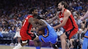 Oct 21, 2025; Oklahoma City, Oklahoma, USA; Oklahoma City Thunder guard Cason Wallace (22) and Houston Rockets forward Tari Eason (17) fight for the ball during the second half at Paycom Center.