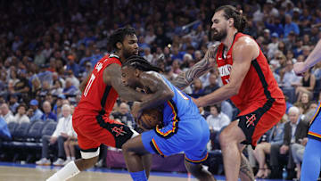 Oct 21, 2025; Oklahoma City, Oklahoma, USA; Oklahoma City Thunder guard Cason Wallace (22) and Houston Rockets forward Tari Eason (17) fight for the ball during the second half at Paycom Center.