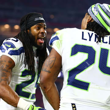 Seahawks cornerback Richard Sherman (25) talks with running back Marshawn Lynch on the sidelines in 2014