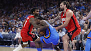 Oct 21, 2025; Oklahoma City, Oklahoma, USA; Oklahoma City Thunder guard Cason Wallace (22) and Houston Rockets forward Tari Eason (17) fight for the ball during the second half at Paycom Center. Mandatory Credit: Alonzo Adams-Imagn Images
