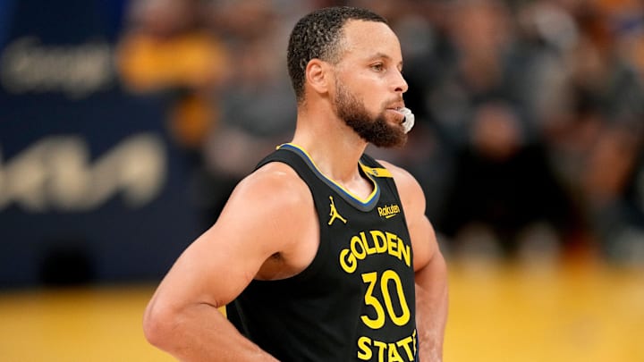 Golden State Warriors guard Stephen Curry stands on the court.