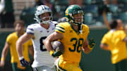 Oct 4, 2025; Waco, Texas, USA; Baylor Bears safety Jacob Redding (38) returns an interception for a touchdown against Kansas State Wildcats tight end Will Swanson (83) during the second half at McLane Stadium. Mandatory Credit: Chris Jones-Imagn Images