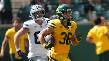 Oct 4, 2025; Waco, Texas, USA; Baylor Bears safety Jacob Redding (38) returns an interception for a touchdown against Kansas State Wildcats tight end Will Swanson (83) during the second half at McLane Stadium. Mandatory Credit: Chris Jones-Imagn Images