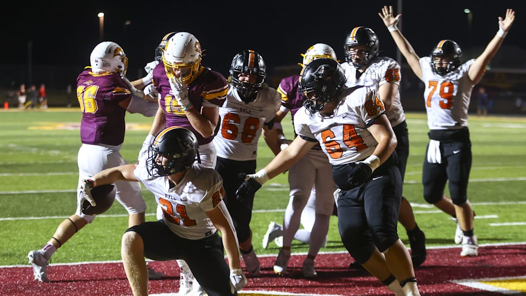 Ryle Raiders' Jacob Savage (21) scores a touchdown during the second half of the high school football game against neighborhood rivals Cooper Jaguars on Friday, Sept. 6, 2024, at Cooper High School. Cooper won 21-14.