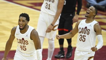 Dec 18, 2023; Cleveland, Ohio, USA; Cleveland Cavaliers guard Donovan Mitchell (45) and forward Isaac Okoro (35) celebrate in overtime against the Houston Rockets at Rocket Mortgage FieldHouse. Mandatory Credit: David Richard-Imagn Images