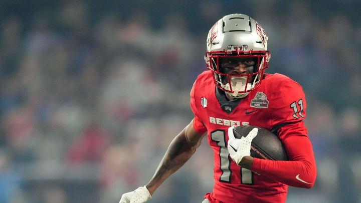 Dec 26, 2023; Phoenix, AZ, USA; UNLV Rebels wide receiver Ricky White (11) runs by Kansas Jayhawks cornerback Kalon Gervin (18) during the first half at Chase Field. Mandatory Credit: Joe Camporeale-USA TODAY Sports