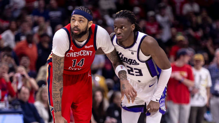 Apr 19, 2024; New Orleans, Louisiana, USA;  New Orleans Pelicans forward Brandon Ingram (14) and Sacramento Kings guard Keon Ellis (23) go for a rebound in the second half during a play-in game of the 2024 NBA playoffs at Smoothie King Center. 