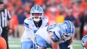 Oct 31, 2025; Syracuse, New York, USA; North Carolina Tar Heels quarterback Gio Lopez (7) with center Austin Blaske (58) at the line of scrimmage in the third quarter against the Syracuse Orange at the JMA Wireless Dome. Mandatory Credit: Mark Konezny-Imagn Images