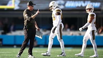 New Orleans Saints head coach Kellen Moore talks to TE Juwan Johnson (83) and WR Chris Olave (12) after a play against the Carolina Panthers on Nov. 9, 2025.