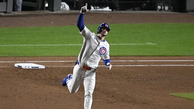 Kyle Tucker of Chicago Cubs raises right arm