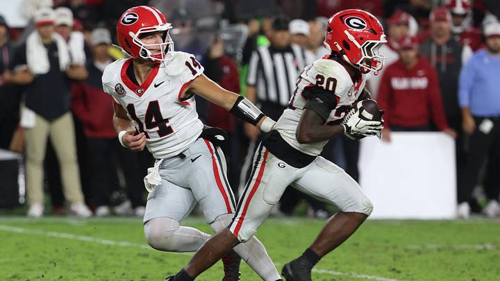 Oct 10, 2026; Tuscaloosa, Alabama, USA;  Georgia Bulldogs quarterback Gunner Stockton (14) hands the ball to running back Dwight Phillips Jr. (20) against the Alabama Crimson Tide during the second quarter at Saban Field at Bryant-Denny Stadium.  Mandatory Credit: David Leong-Imagn Images