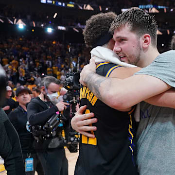 May 26, 2022; San Francisco, California, USA; Dallas Mavericks guard Luka Doncic (77) hugs Golden State Warriors guard Klay Thompson (11) after game five of the 2022 western conference finals against the Dallas Mavericks at Chase Center. Mandatory Credit: Cary Edmondson-Imagn Images